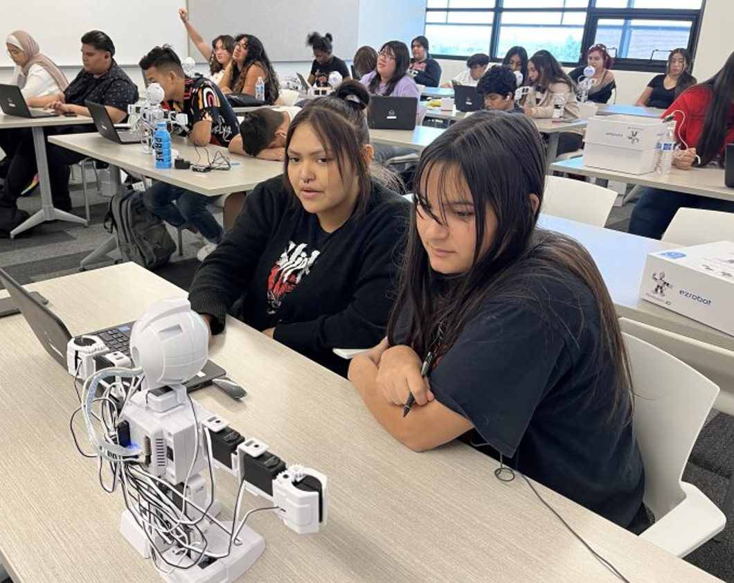 Upward Bound students building and testing robots